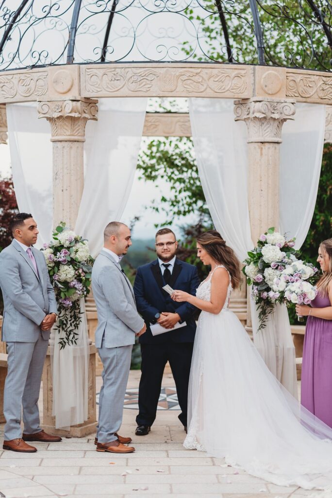 the aria in prospect connecticut has a couple getting married under their unique wedding venue arch outdoors