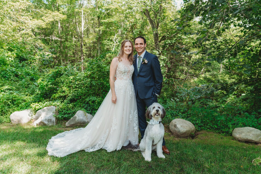 bride and groom posing for wedding photos with their dog