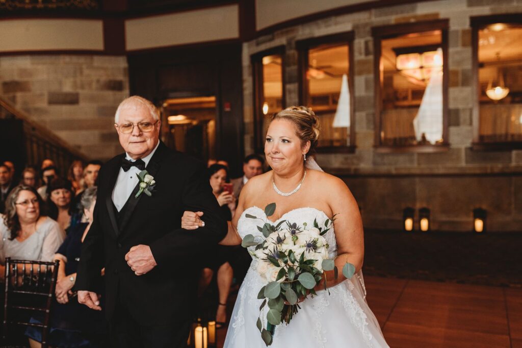 bride being escorted down the aisle