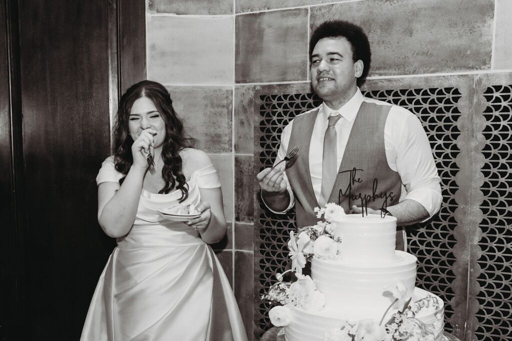 bride and groom eat their wedding cake