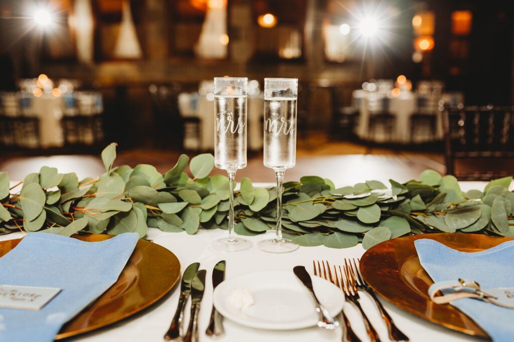 Mr. and Mrs. champagne glasses at sweetheart table