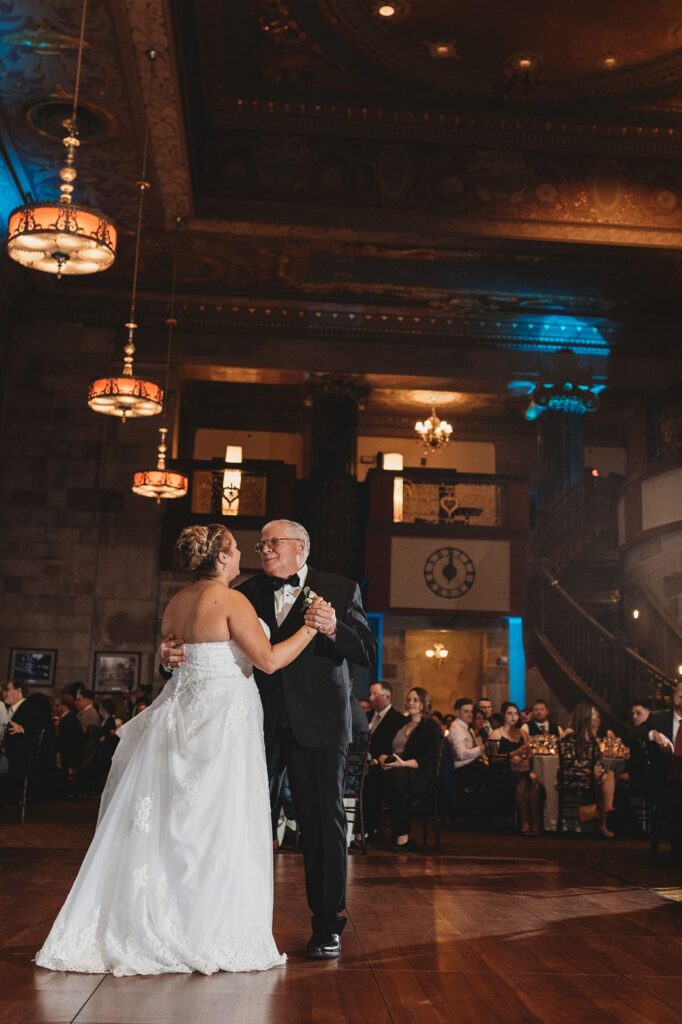 bride dances with father during wedding reception