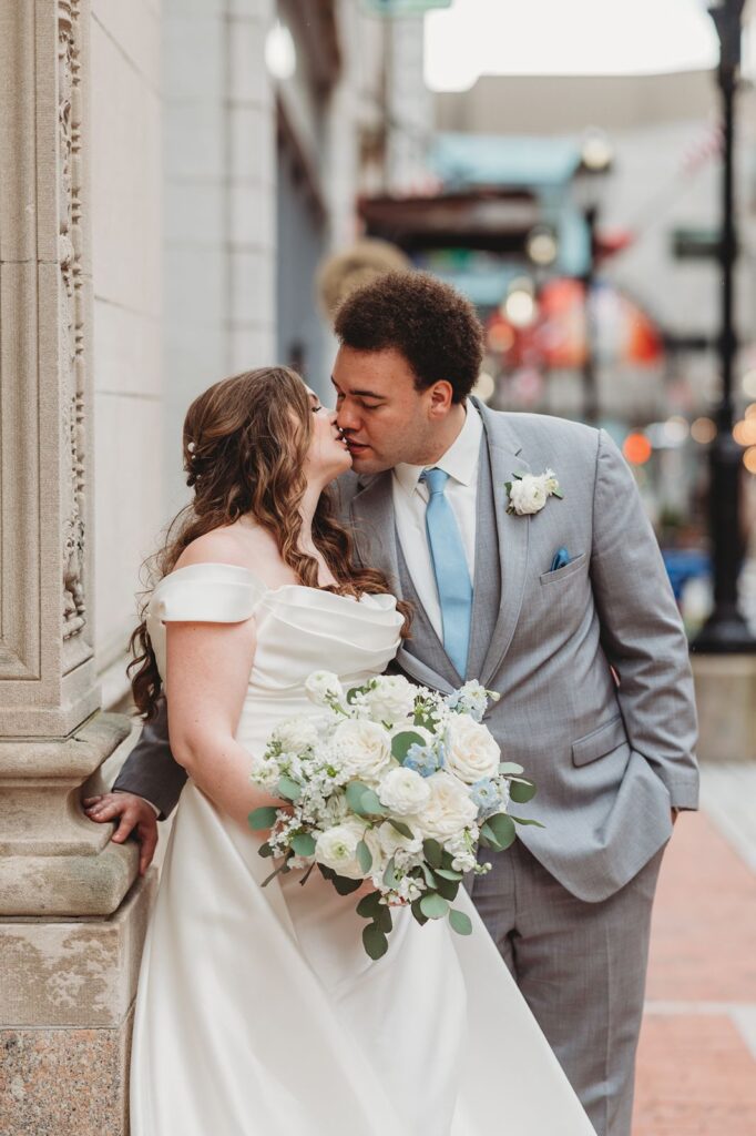 groom leans into kiss bride