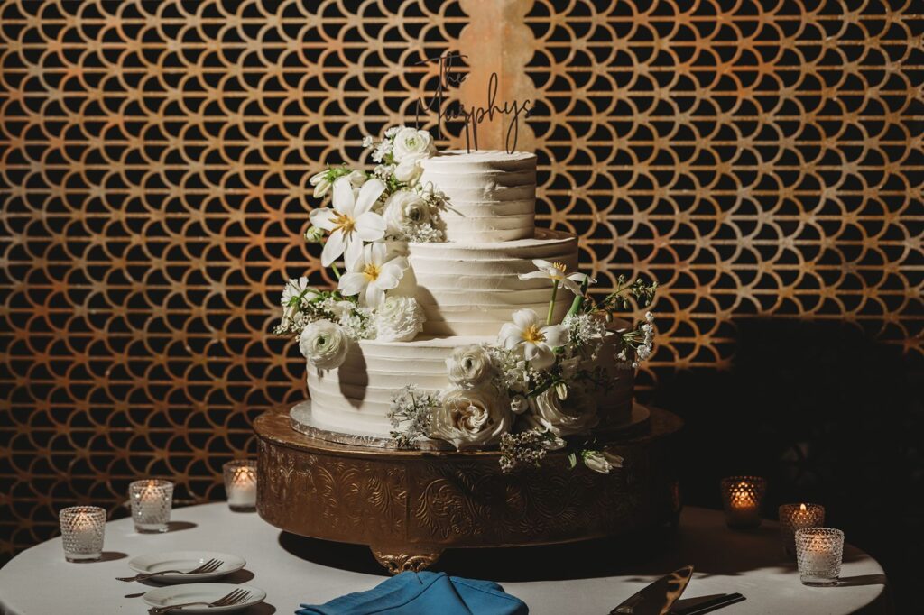 three tiered wedding cake with all white flowers