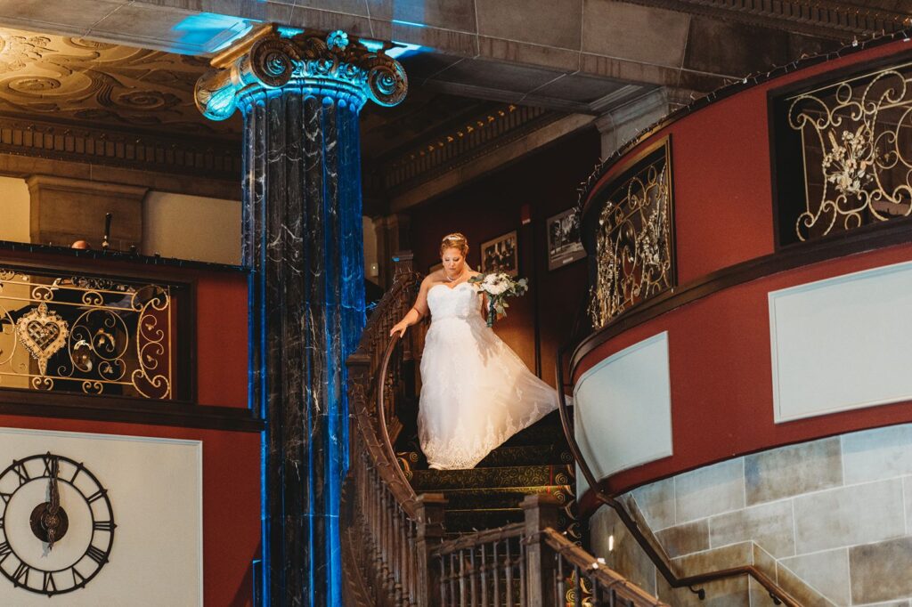 bride walking down the grand staircase at Hartford, CT wedding venue