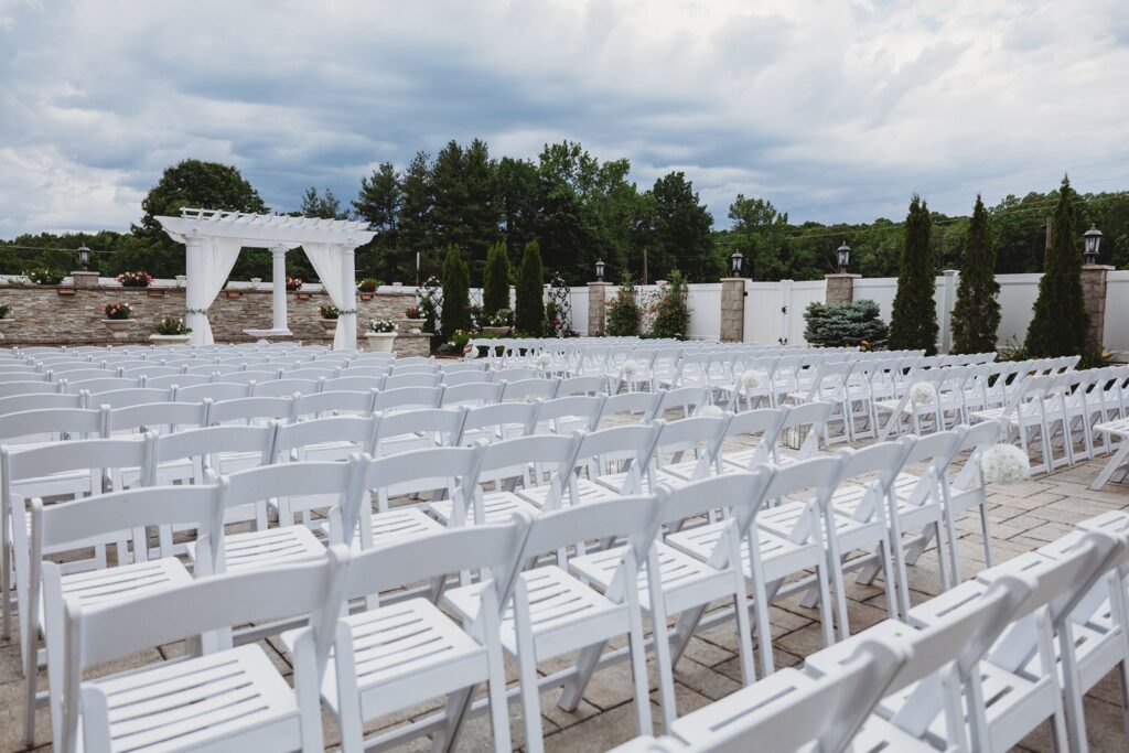 The private courtyard ceremony area with chiavari chairs at La Bella Vista Waterbury.
