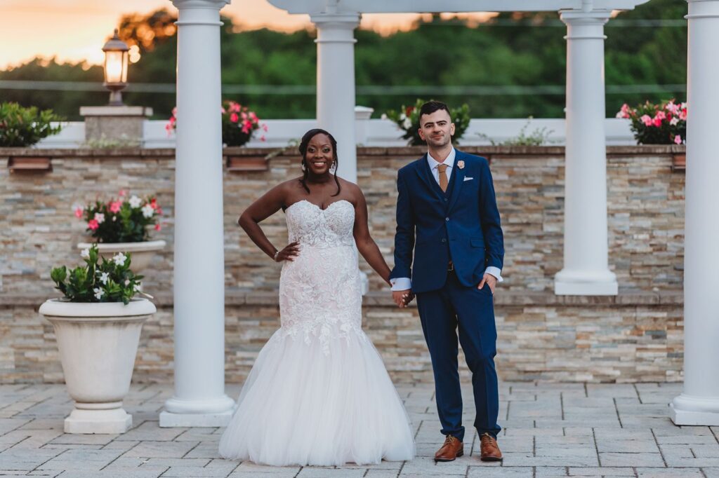 Couple poses and holds hands by the ceremony site at La Bella Vista.