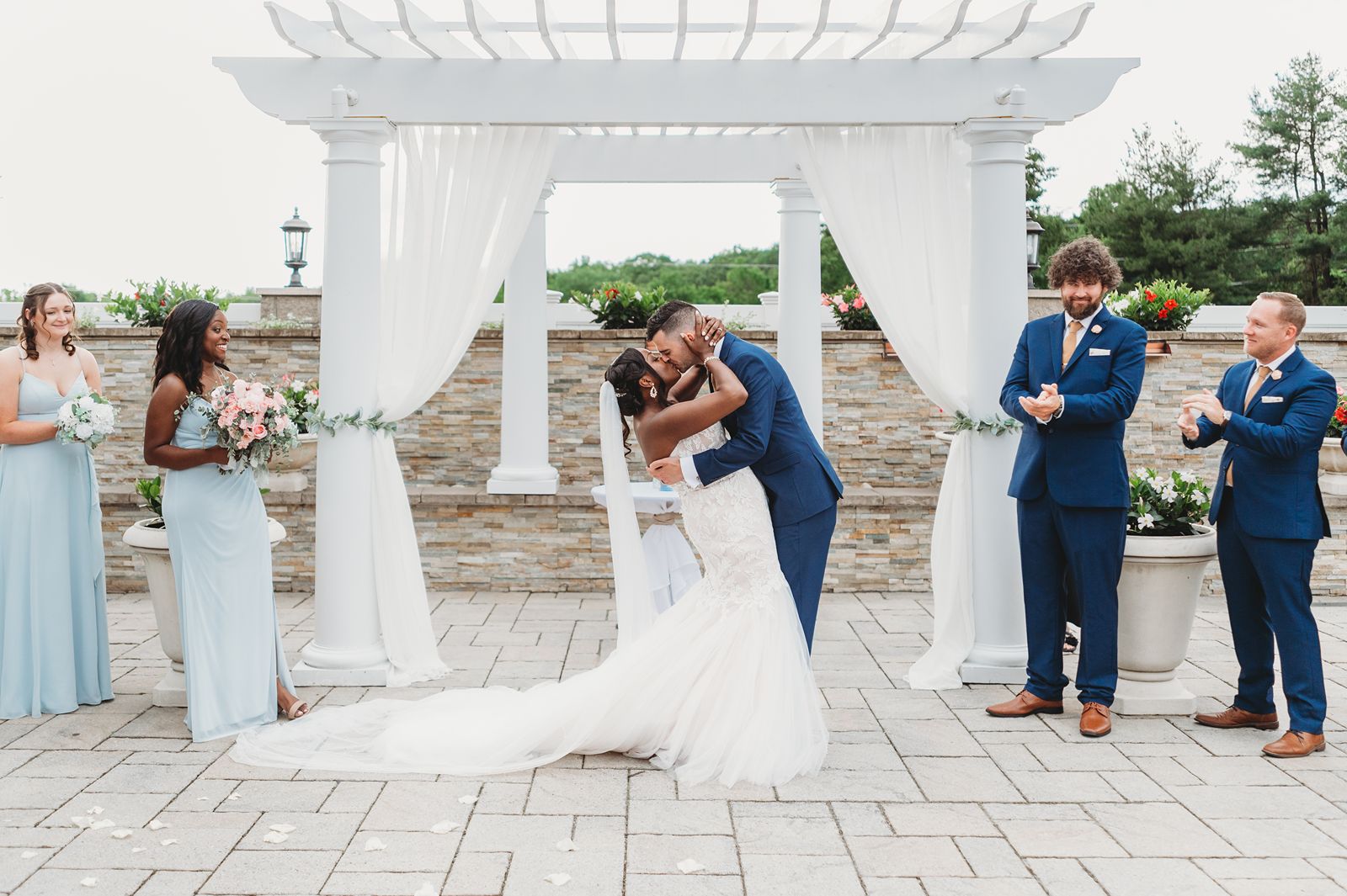 Bride and groom share their first kiss during their la bella vista waterbury ceremony
