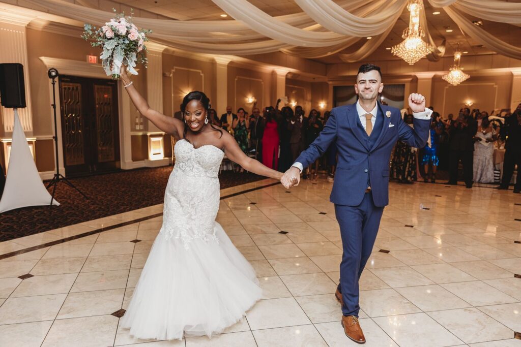 Bride and groom celebrating as they enter their reception.