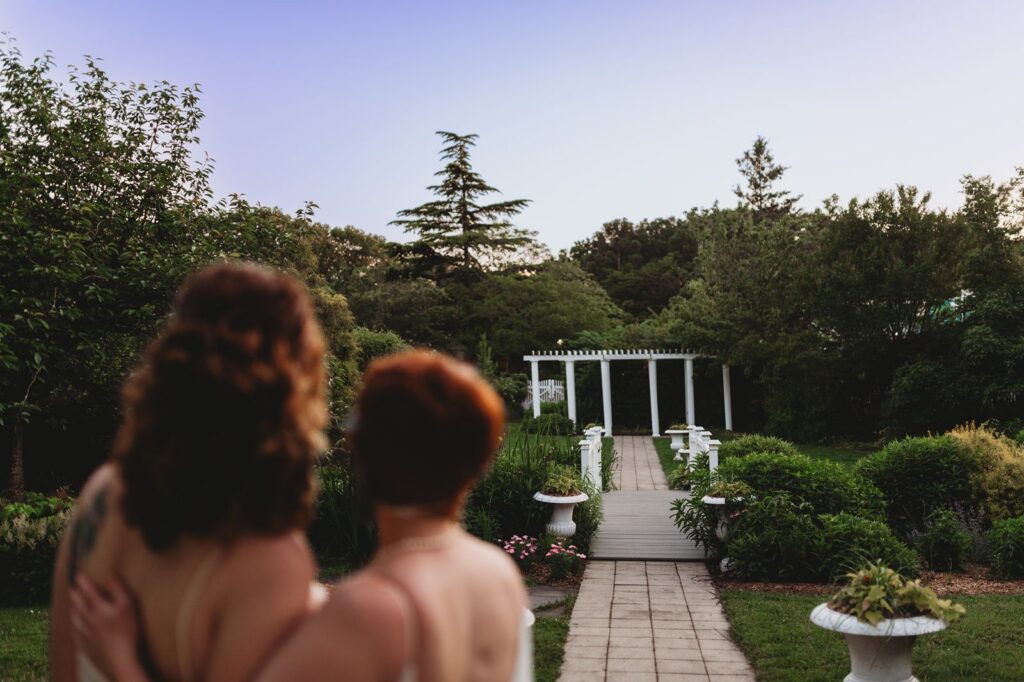 a couple looks back down the path where they got married earlier