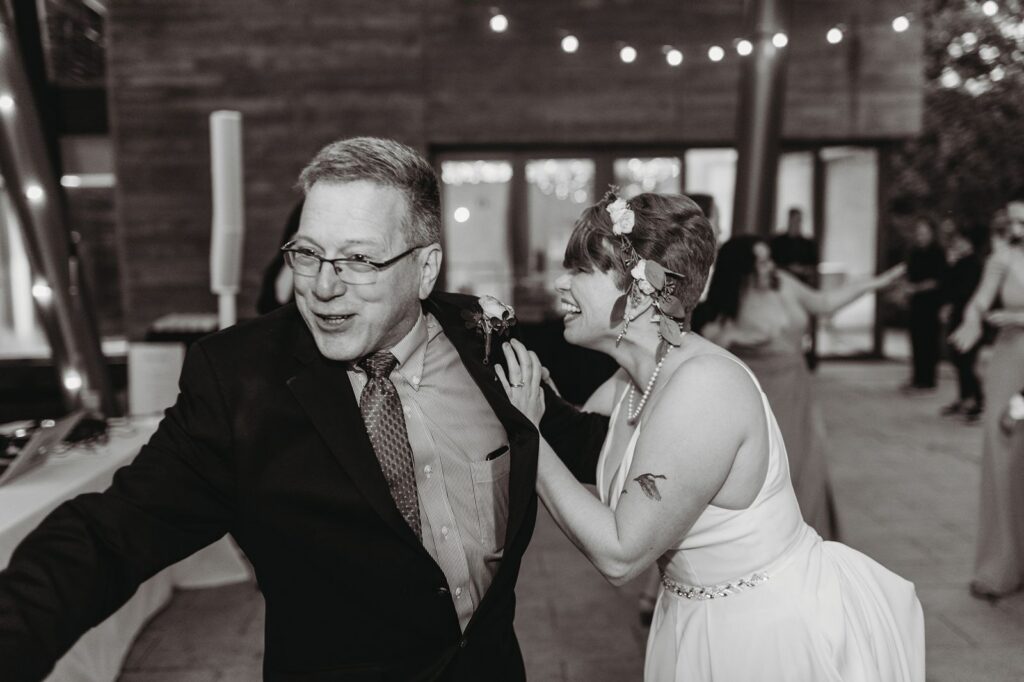 bride laughing with dad at the hora
