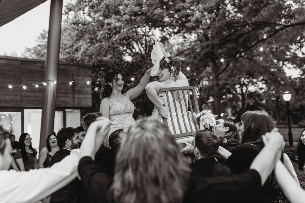 bride being lifted into the air for the hora