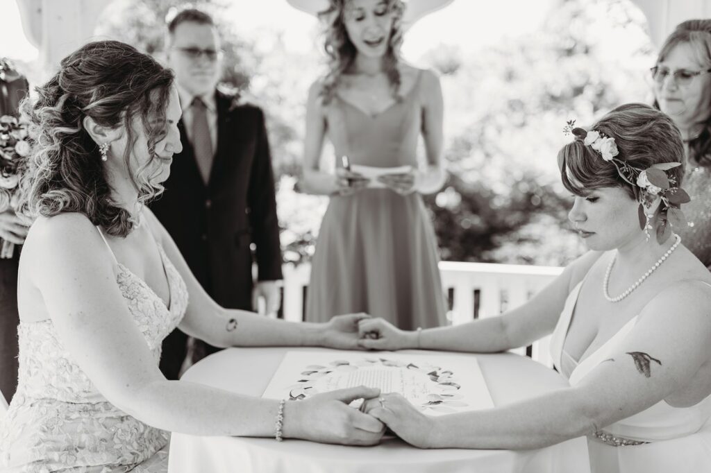 praying after signing the ketubah in the ceremony garden gazebo