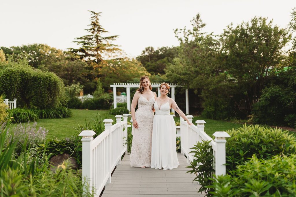 a couple walking down the bridge in the ceremony garden