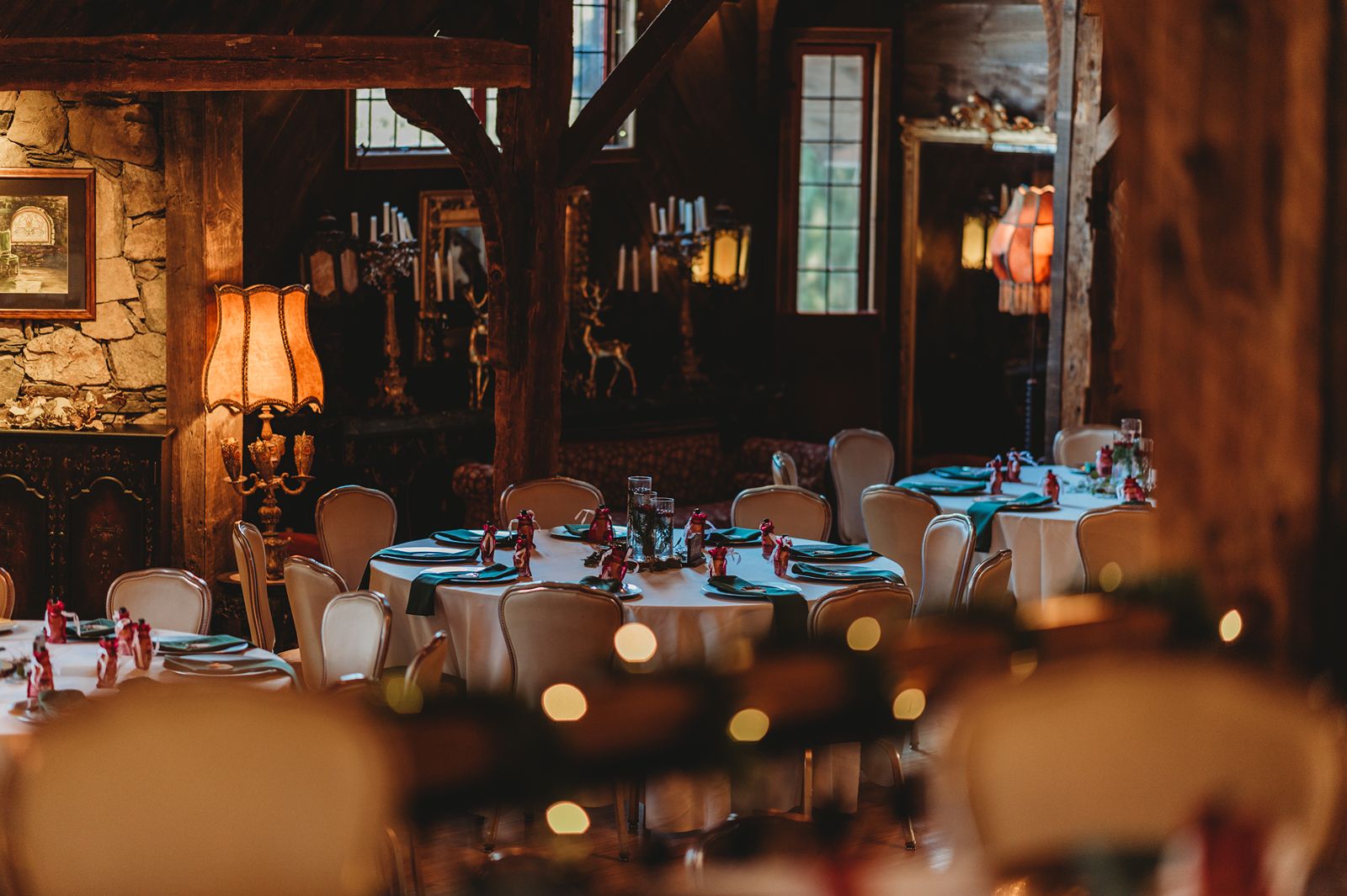 Candlelit reception room with warm wood and wintery place settings