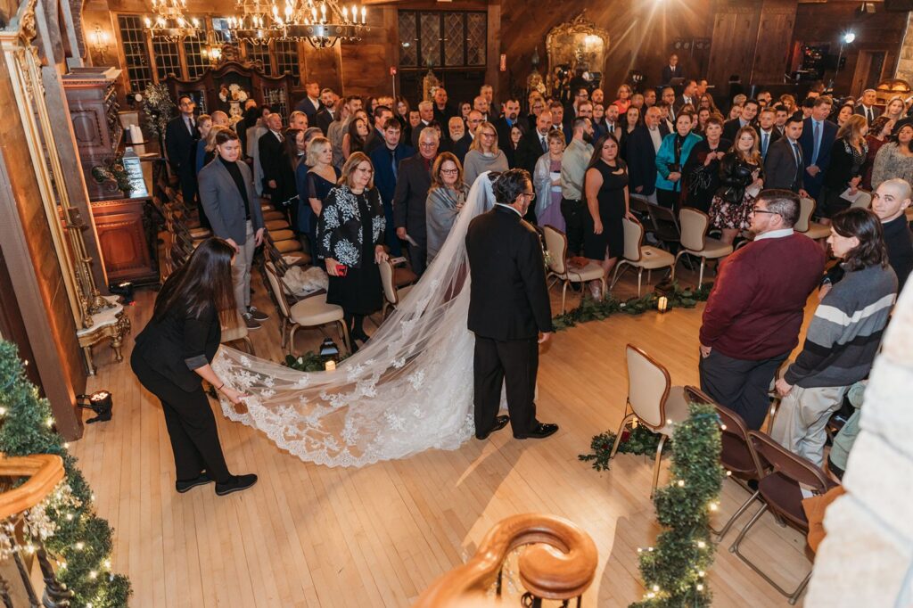 Bill Miller's Castle coordinator preparing bride to walk down aisle by fixing her veil